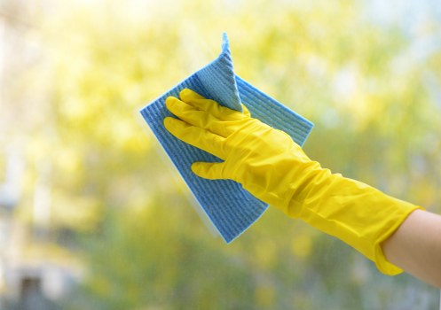 Local technician cleaning curtains in a Belsizepark property